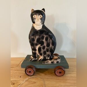Primitive wooden cat on a pull string cart